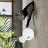 Cat-shaped wall light fixture on a wall with a plant in the foreground